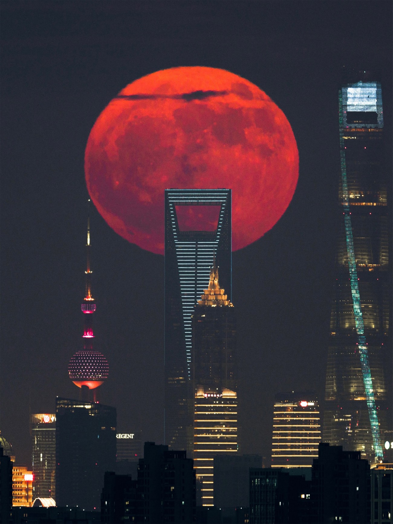 Red Full Moon rising beside Shanghai’s tallest skyscrapers in Lujiazui