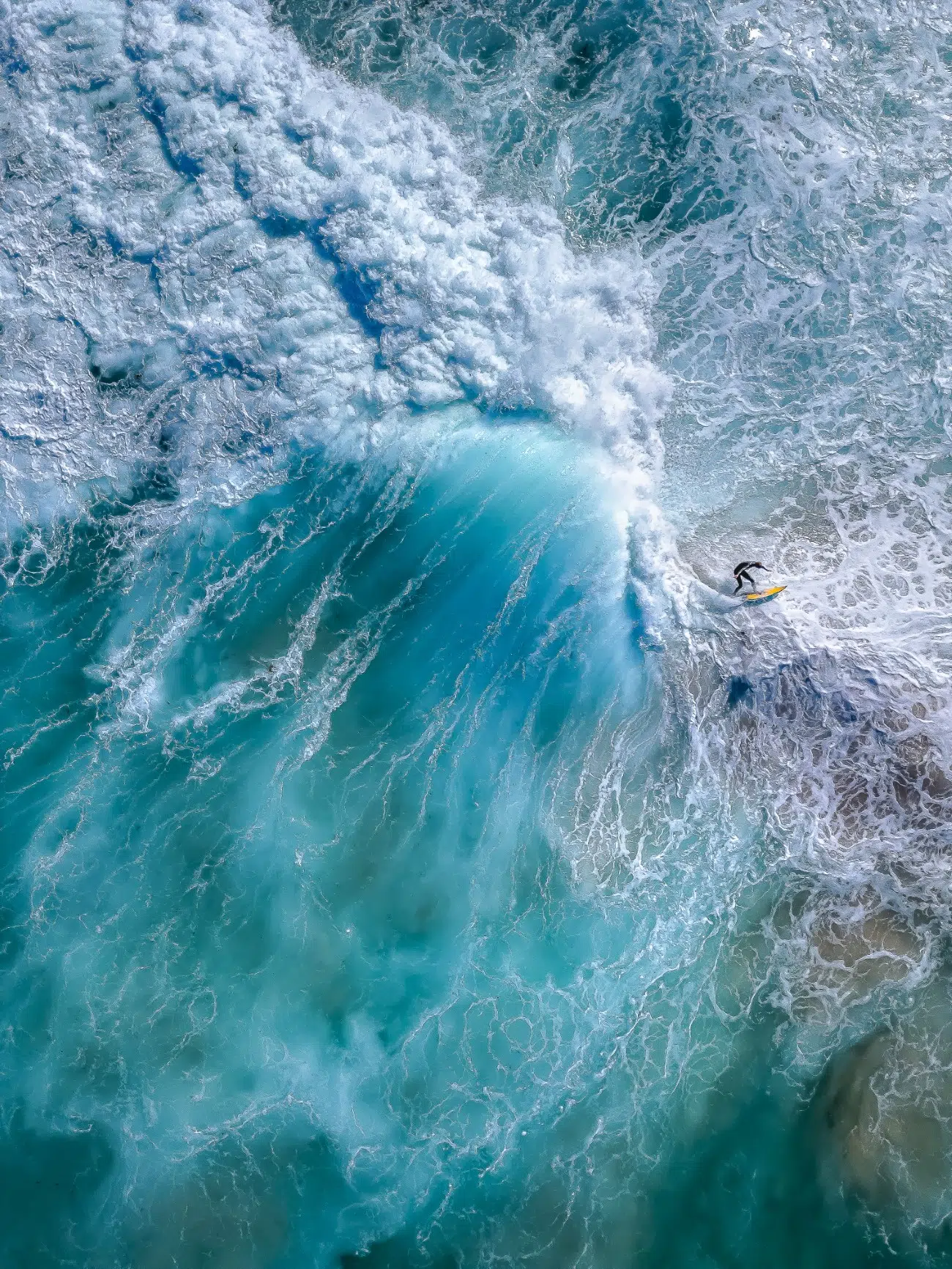 Aerial view of surfers on large waves