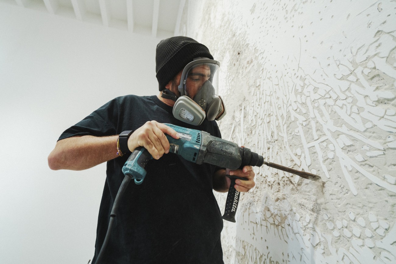 Vhila chiseling wall